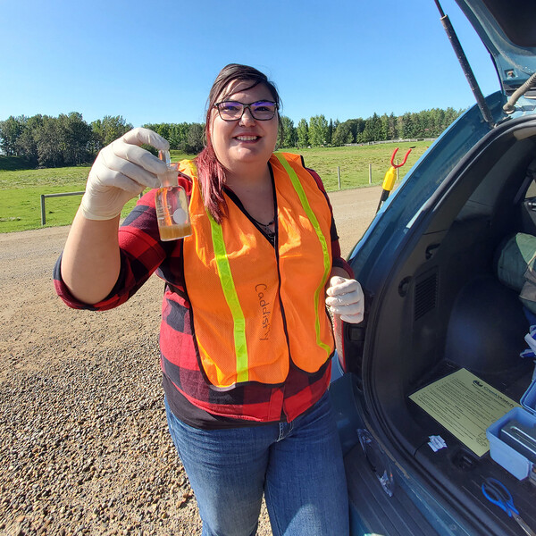 Pamela helping the Medicine River Watershed Society take water samples.