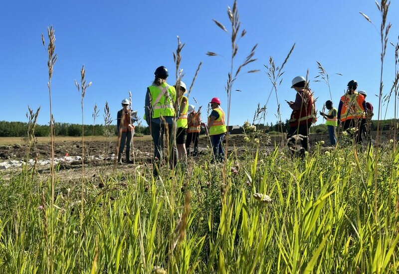 People outside at a wetland contstruction and restoration course.