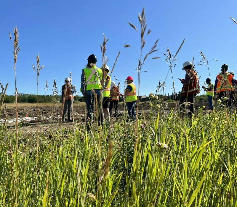 People outside at a wetland contstruction and restoration course.