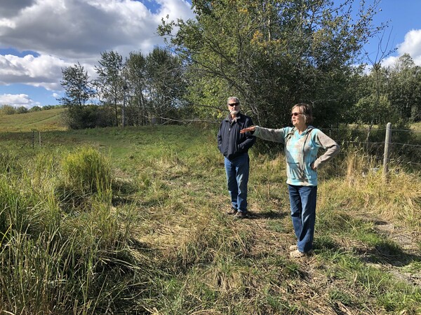Claude and Patti Albert pointing out key features on their acreage.
