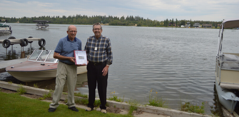 Presenting a binder to longtime resident, Ken L.